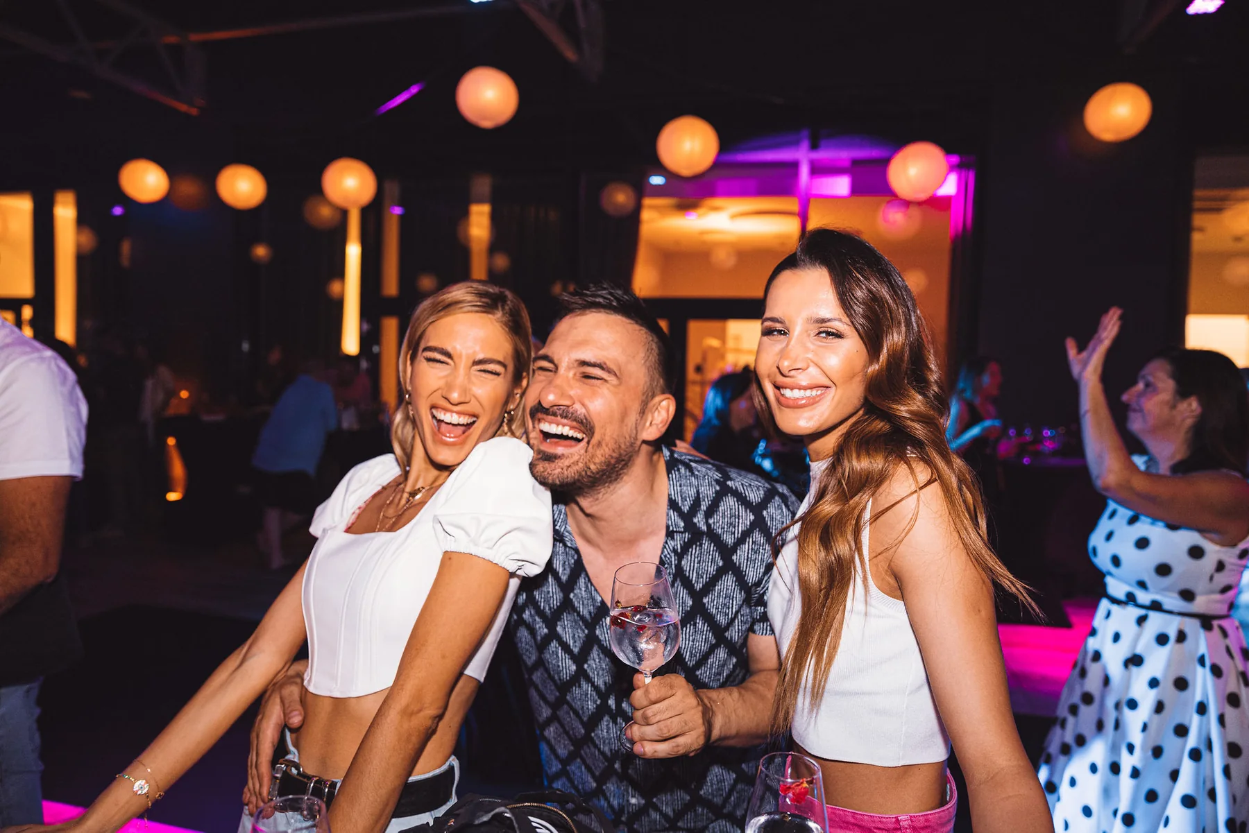 Published hero image from the Dentelli Fashion Show afterparty with guests under the event lighting