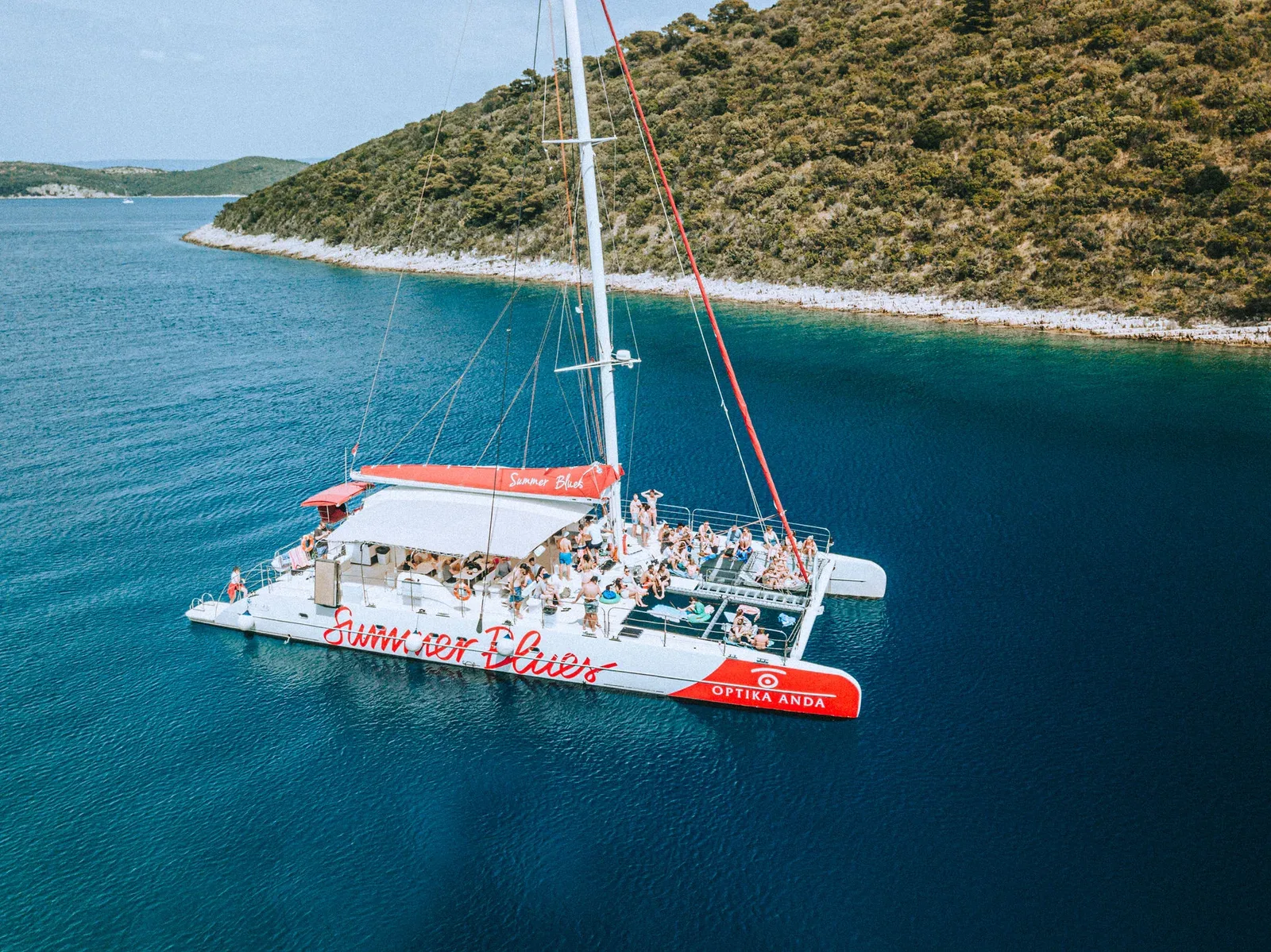 Summer Blues catamaran in turquoise water with guests on board
